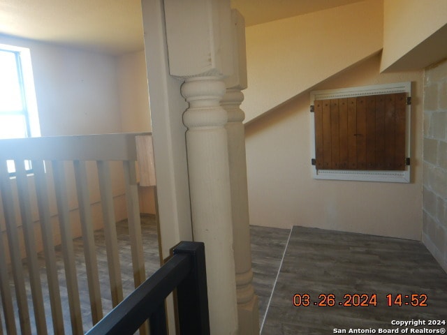 hallway with dark hardwood / wood-style flooring