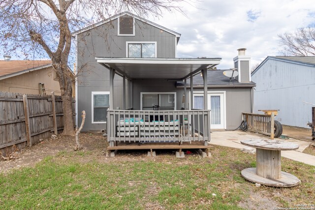 rear view of house with a wooden deck