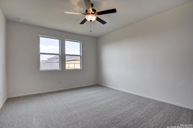 empty room with ceiling fan and carpet flooring