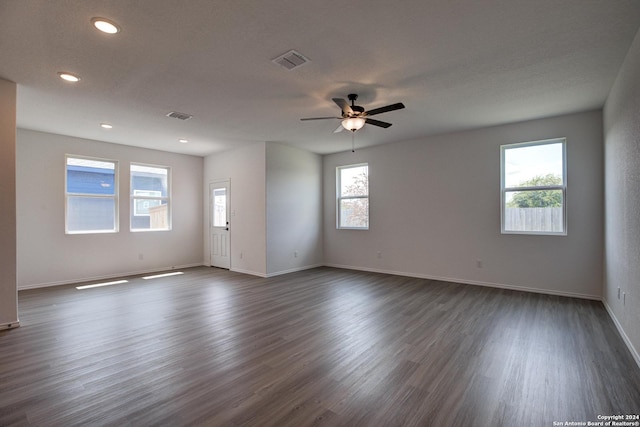 unfurnished room with dark hardwood / wood-style flooring, a textured ceiling, and ceiling fan