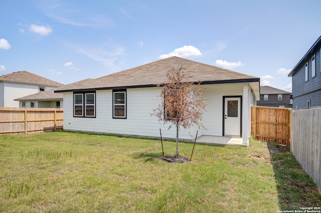 rear view of house with a lawn