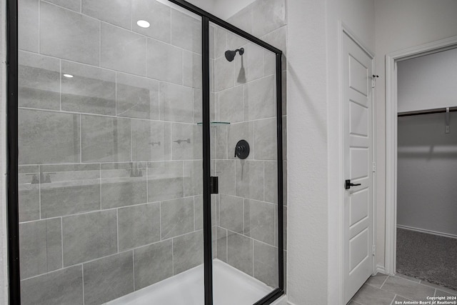 bathroom with a shower with door