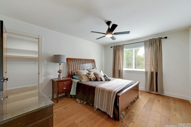 bedroom with light hardwood / wood-style floors and ceiling fan