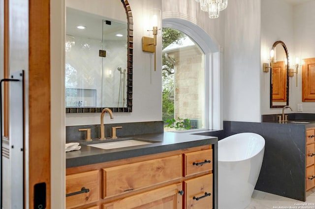 bathroom featuring a tub, oversized vanity, and a chandelier