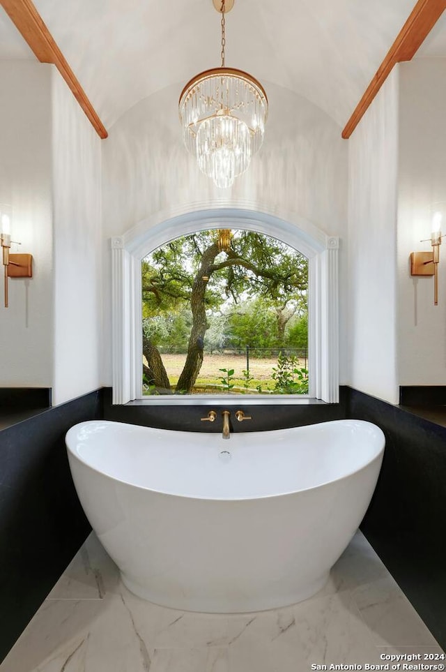 bathroom with a notable chandelier, tile flooring, and lofted ceiling