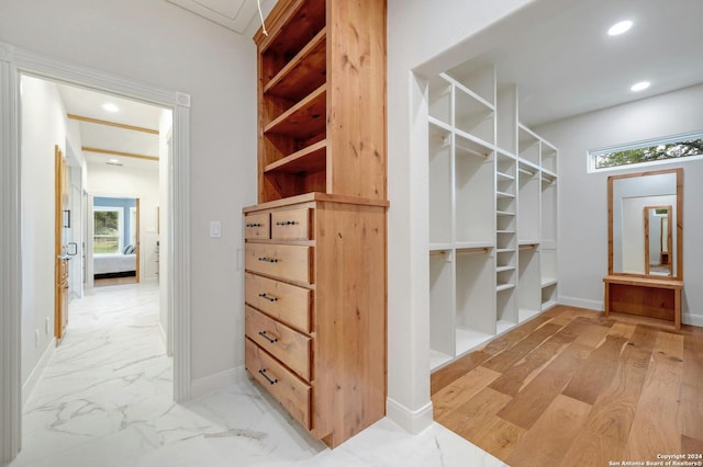 walk in closet featuring light hardwood / wood-style flooring