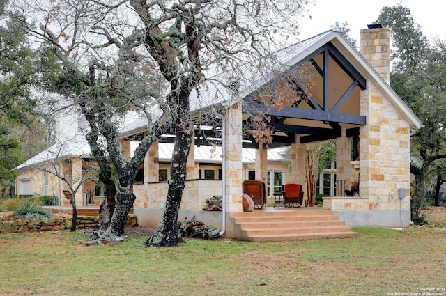 rear view of house featuring a yard