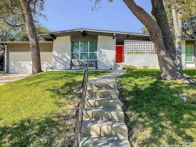 single story home with a front lawn and a garage