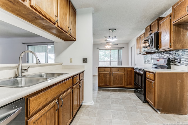 kitchen featuring ceiling fan, stainless steel appliances, sink, pendant lighting, and light tile floors