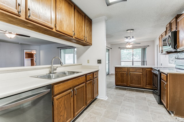 kitchen featuring ceiling fan, light tile floors, a textured ceiling, sink, and stainless steel appliances