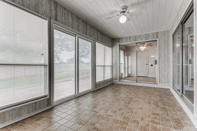 unfurnished sunroom with wooden ceiling and ceiling fan