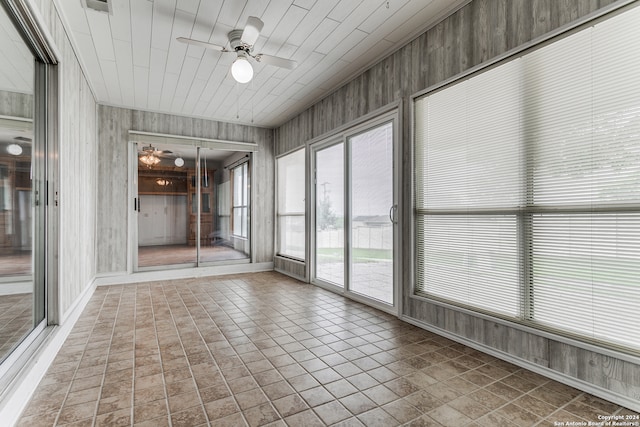 unfurnished sunroom with ceiling fan