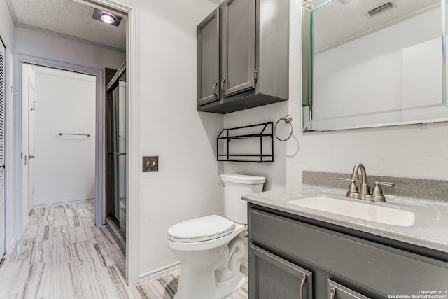 bathroom featuring walk in shower, toilet, oversized vanity, and a textured ceiling