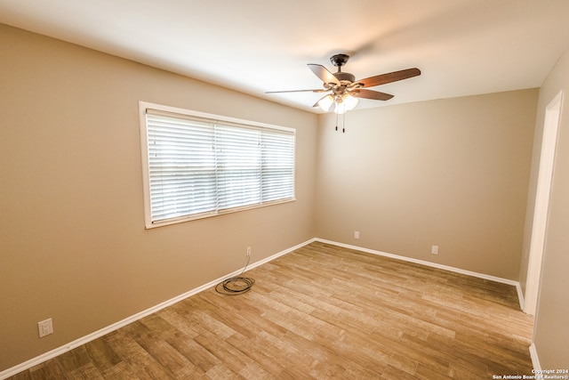 unfurnished room with ceiling fan and light wood-type flooring