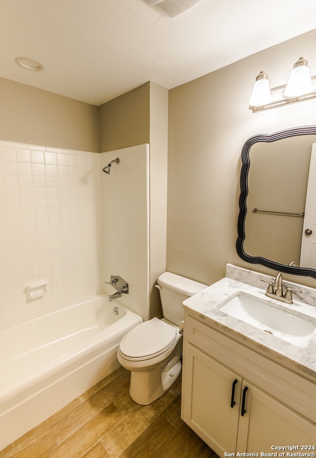 full bathroom featuring vanity, hardwood / wood-style floors, shower / bathtub combination, and toilet