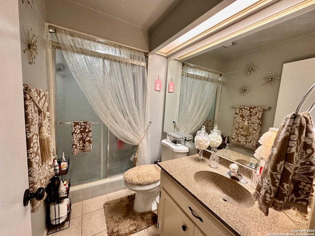 bathroom with tile floors, oversized vanity, toilet, and walk in shower