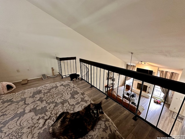 stairway featuring lofted ceiling and dark wood-type flooring