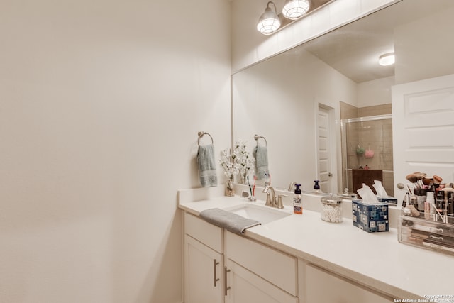 bathroom featuring vanity with extensive cabinet space and an enclosed shower