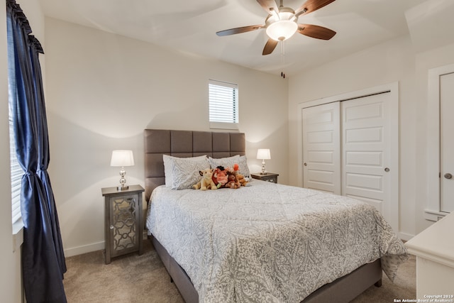 carpeted bedroom featuring a closet and ceiling fan