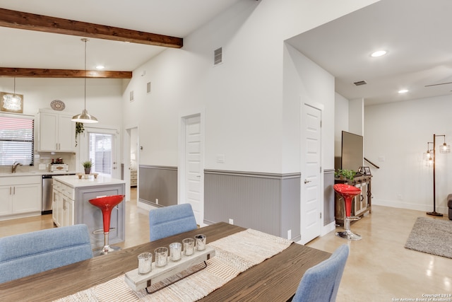 dining room featuring sink and lofted ceiling