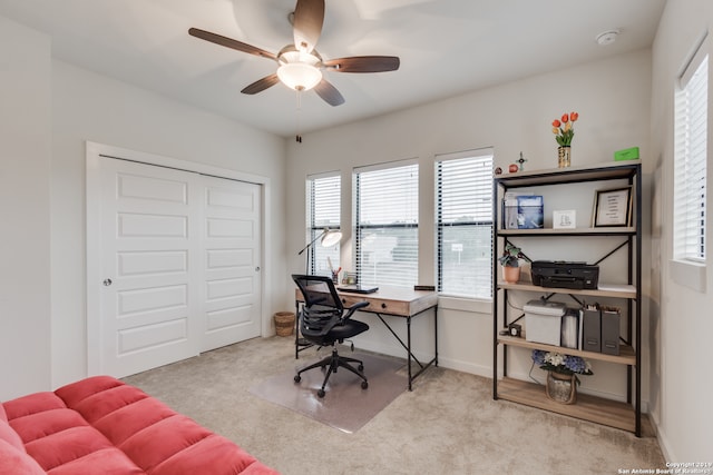 carpeted office space featuring a wealth of natural light and ceiling fan