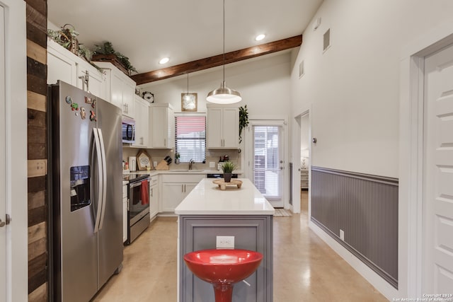 kitchen with a kitchen island, vaulted ceiling with beams, white cabinetry, hanging light fixtures, and stainless steel appliances