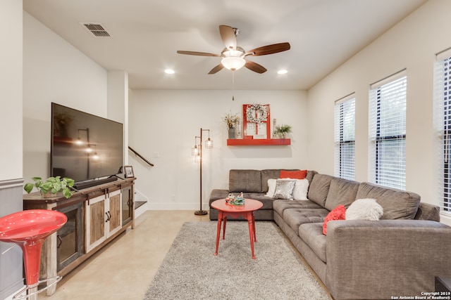 carpeted living room featuring ceiling fan