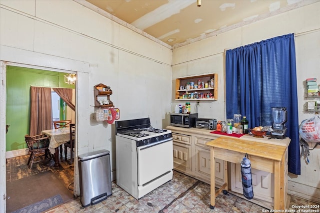 kitchen featuring white range with gas stovetop