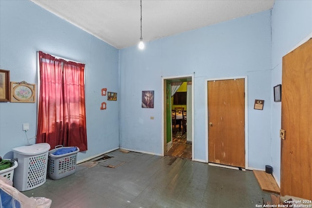 misc room featuring a high ceiling and dark wood-type flooring