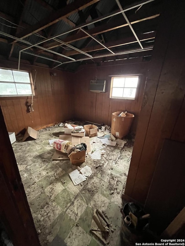 miscellaneous room with wood walls