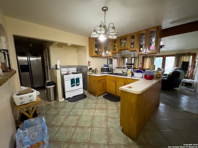 kitchen with hanging light fixtures, stainless steel appliances, kitchen peninsula, and light tile floors