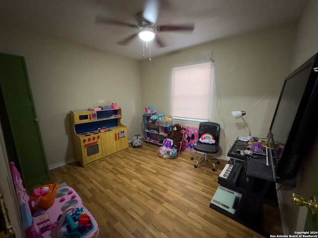 recreation room featuring light hardwood / wood-style flooring and ceiling fan