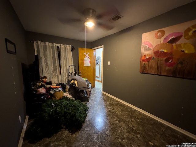 bedroom featuring dark tile flooring and ceiling fan