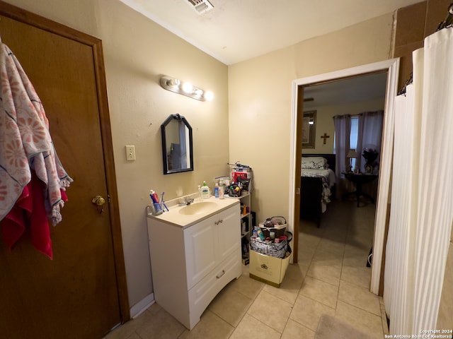 bathroom with vanity with extensive cabinet space and tile floors