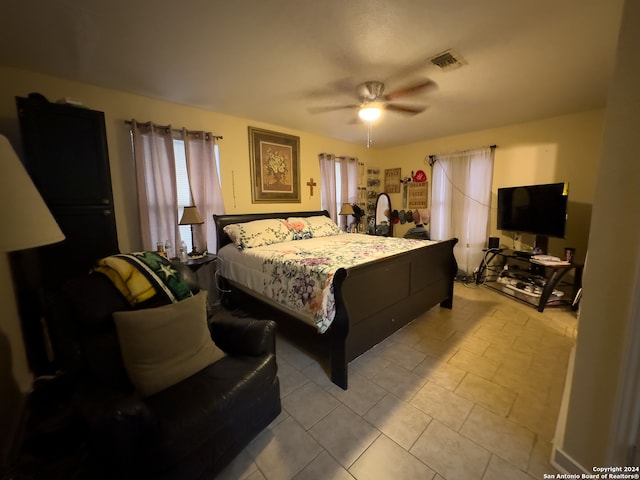 bedroom featuring ceiling fan and light tile floors