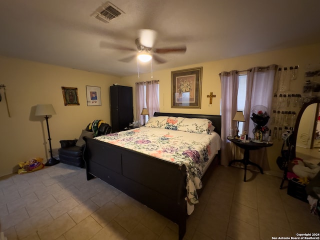 tiled bedroom with ceiling fan