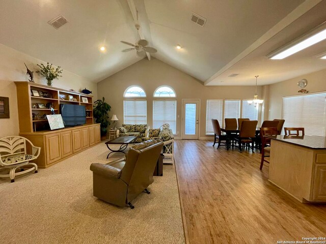 54 Pelican Prt, Oconnor, TX 77982 - living room with ceiling fan with notable chandelier, light hardwood / wood-style flooring, high vaulted ceiling, and beam ceiling