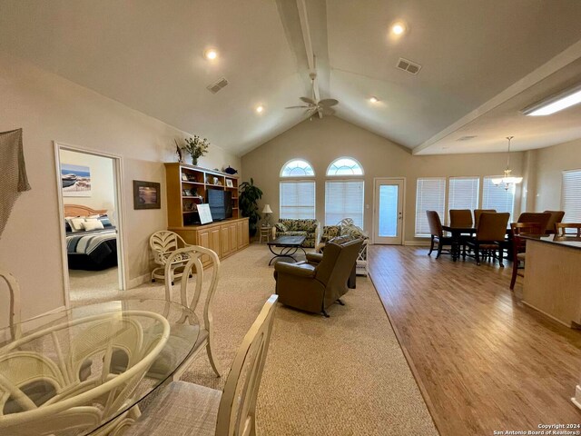 54 Pelican Prt, Oconnor, TX 77982 - living room with high vaulted ceiling, beam ceiling, ceiling fan with notable chandelier, and light wood-type flooring