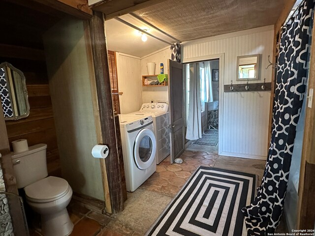 laundry room featuring separate washer and dryer and light tile floors