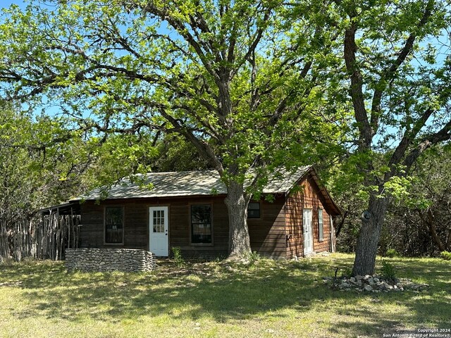 back of property with a yard