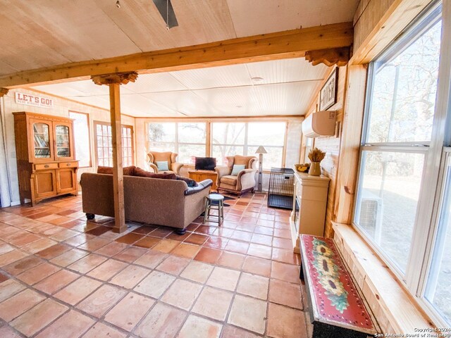 living room featuring beam ceiling and light tile floors