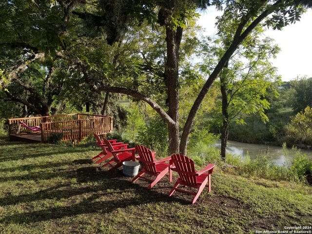 view of yard with a deck with water view