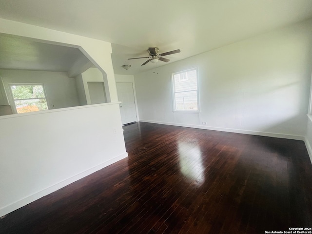 unfurnished room with ceiling fan and dark hardwood / wood-style floors