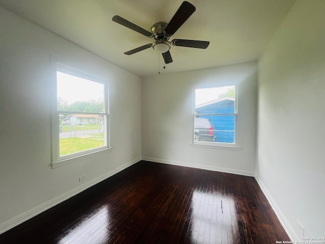 unfurnished room with dark hardwood / wood-style floors and ceiling fan