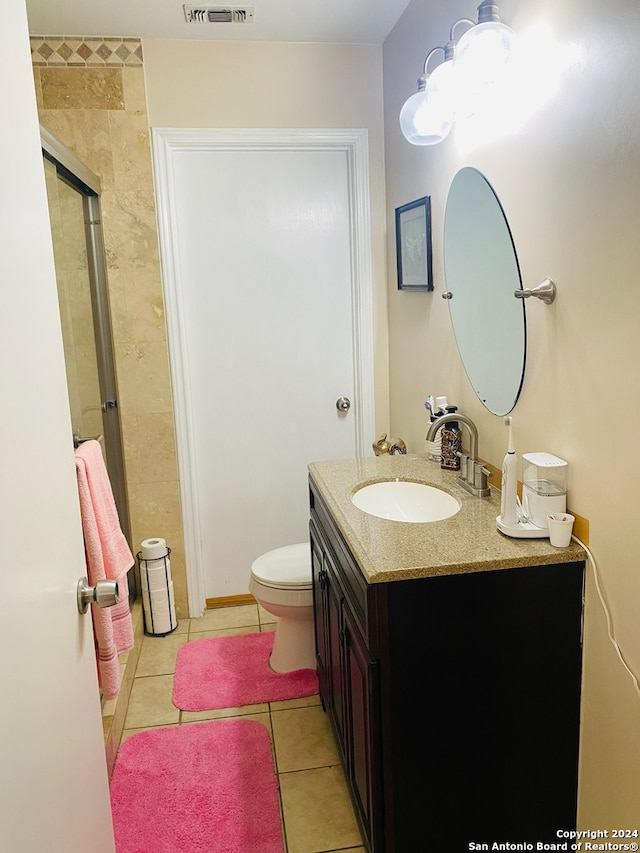 bathroom featuring vanity, toilet, and tile patterned floors