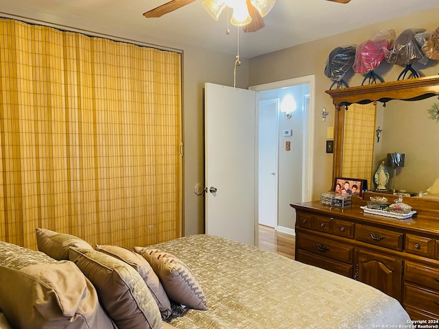 bedroom with light hardwood / wood-style flooring and ceiling fan