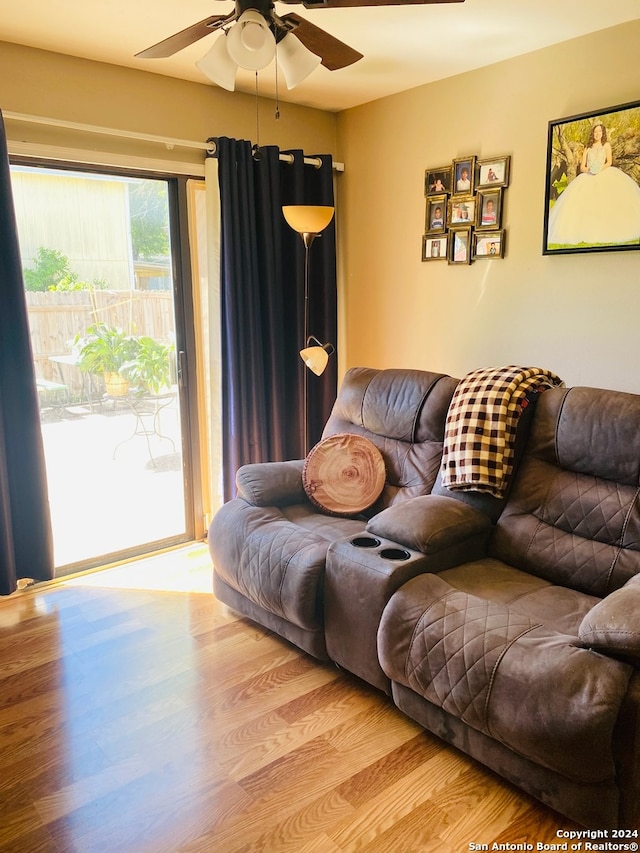 living room featuring light hardwood / wood-style flooring and ceiling fan