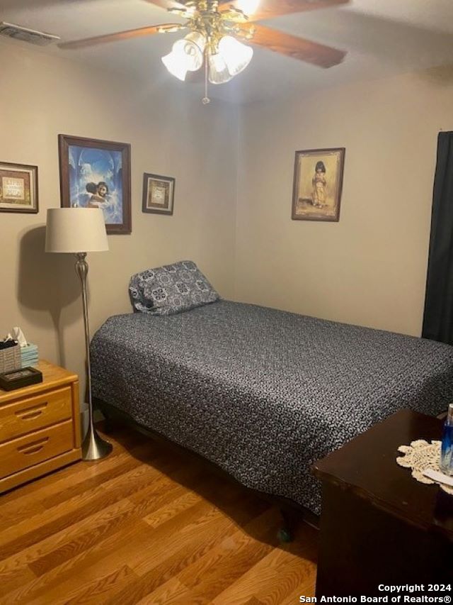 bedroom with hardwood / wood-style flooring and ceiling fan