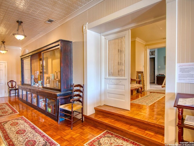 hallway with ornamental molding and parquet flooring