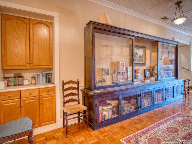 interior space with light parquet floors and crown molding